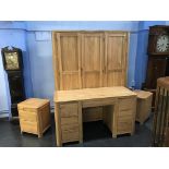 A modern light wood triple door wardrobe, a pair of bedside cabinets and a dressing table