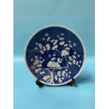 A Chinese blue and white circular wall plate, decorated with blossoming branches, 28cm diameter