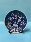 A Chinese blue and white circular wall plate, decorated with blossoming branches, 28cm diameter