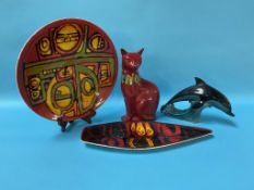 A Poole pottery cat, 29cm high, a Dolphin and a Poole charger, 24cm diameter and Poole Spear dish (