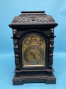 A large Victorian heavily carved oak bracket clock, with eight day movement, Whittington and