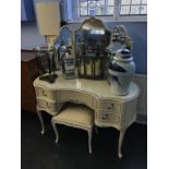 A cream and gilt dressing table and stool