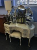 A cream and gilt dressing table and stool