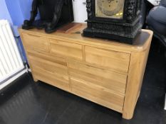 A modern light oak chest of seven drawers, 138cm wide
