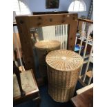 A circular wicker linen basket and a pine mirror