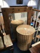 A circular wicker linen basket and a pine mirror