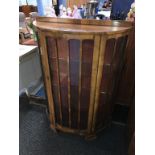 A walnut demi lune china cabinet