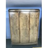 A walnut triple door wardrobe