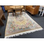 A beige Chinese carpet, 286cm x 186cm