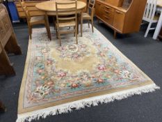 A beige Chinese carpet, 286cm x 186cm