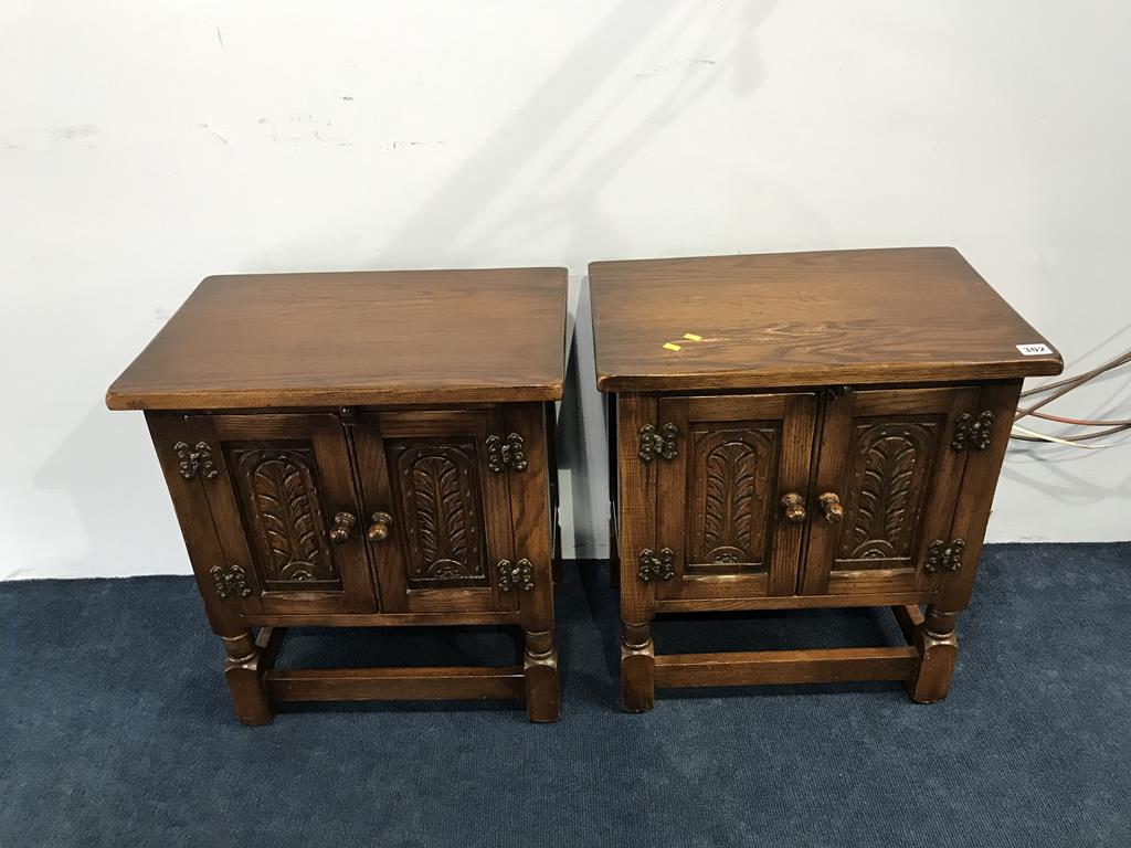 A pair of oak two door cabinets, 50cm x 33cm x 57cm