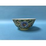 A Chinese famille rose bowl, on yellow ground, 15cm diameter