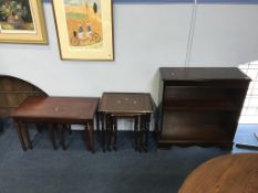 A reproduction nest of tables, coffee table and a bookcase