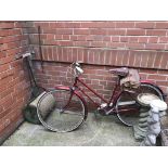A Vintage cycle and a garden roller