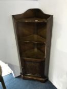 An oak corner cabinet