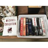 A collection of Michael Crichton 1st edition books