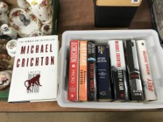 A collection of Michael Crichton 1st edition books