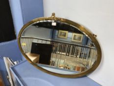 A heavy brass oval mirror, 73cm wide