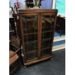 An oak leaded glass bookcase & an armchair