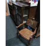 A mahogany china cabinet and bergère armchair