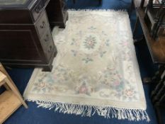 A beige Chinese style rug, 122cm wide x 200cm long