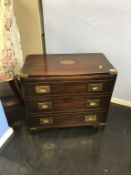 A reproduction mahogany campaign style chest of three drawers, with brushing slide, 61cm wide