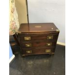 A reproduction mahogany campaign style chest of three drawers, with brushing slide, 61cm wide