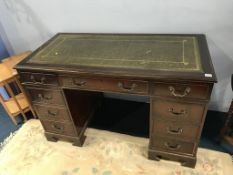 A reproduction mahogany pedestal desk