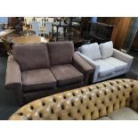 A brown two seater settee and cream settee