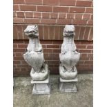 A pair of garden gargoyles on stands