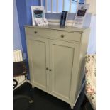 A pale green two door cabinet, with single drawer, 98cm wide