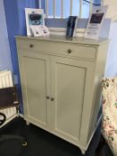 A pale green two door cabinet, with single drawer, 98cm wide