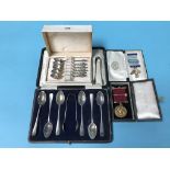 A cased set of silver spoons, silver gilt Masonic medals and a set of Continental spoons