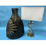 A large modern vase and a table lamp