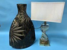 A large modern vase and a table lamp