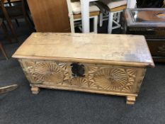 A Continental light oak carved coffer