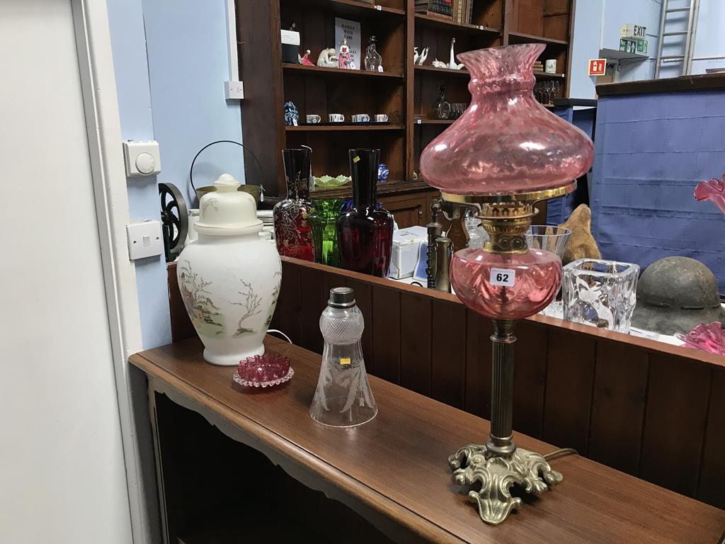 A converted oil lamp, a glass vase converted to a table lamp etc.