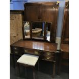 A reproduction mahogany campaign style double door wardrobe and dressing table with stool