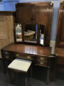 A reproduction mahogany campaign style double door wardrobe and dressing table with stool