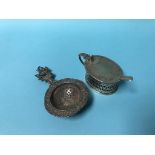 A silver mustard pot and a tea strainer