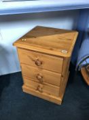 A pair of pine bedside drawers