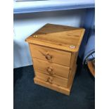 A pair of pine bedside drawers