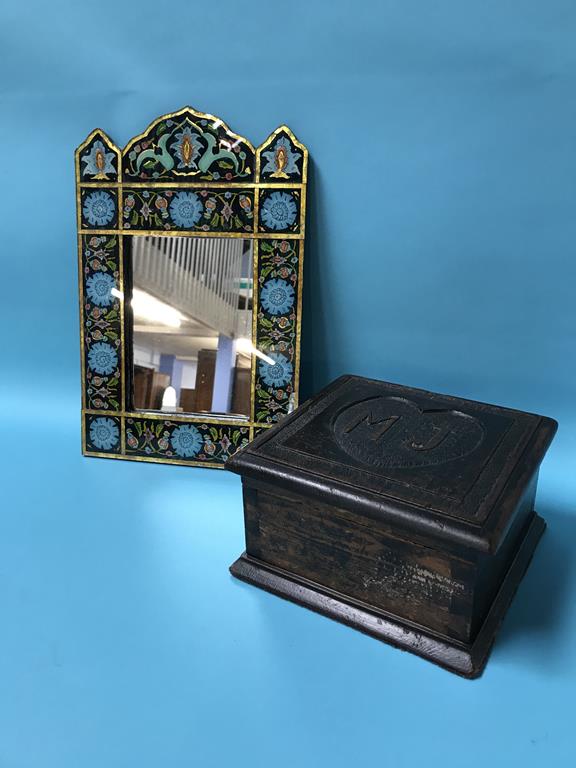 A small carved wood box and a decorative mirror