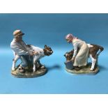 A pair of Royal Copenhagen figures of a boy pulling a cow and a girl feeding a cow