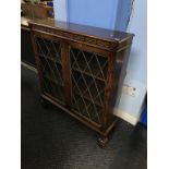 An oak leaded glass bookcase