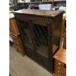 An oak linenfold china cabinet