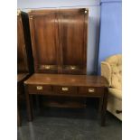 A reproduction mahogany campaign style double door wardrobe and three drawer side table