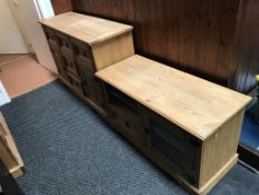 A pine chest of drawers and pine base unit