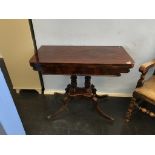 A 19th century mahogany fold over tea table