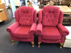 A pair of red wing armchairs